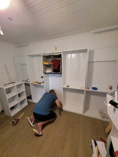 Creating a "built in closet" out of Walmart Bookshelves and hanging rods for our bedroom.