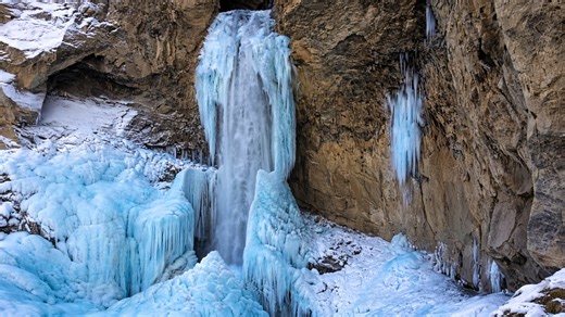 Frozen waterfall in winter cliffs