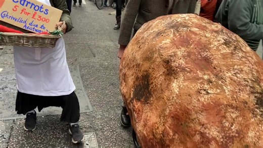 Extinction Rebellion march with a giant potato on second day of their three-day insurance protest in London