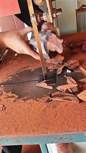 cutting wood pieces using a band saw machine to create art or furniture parts
