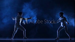 Two female athletes train on foil at fencing tournament. Young swordsmen in white uniforms and fencing masks fight duel on dark studio background with smoke and blue light. Fencing school. Slow motion