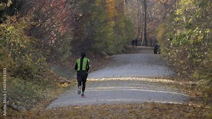 Running Man In Autumn Forest. Runner Man Fit Athlete Legs Jogging On Trail Preparing For Ultra Race.Triathlete Running,Sprinting And Endurance Workout Training. Sport Concept.