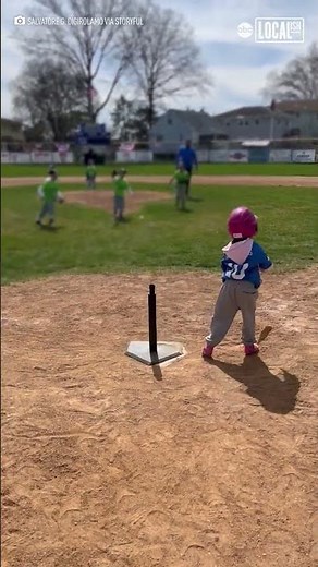 Little girl cartwheels during softball game