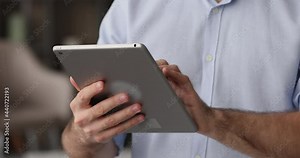 Male hands holds tablet lead correspondence to client remotely by e-mail, close up. Busy entrepreneur using device provide counsel help distantly, share text messages, modern tech, connection concept