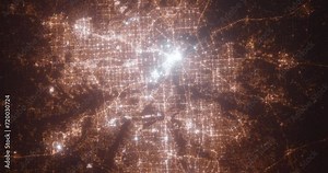 Dallas and Fort Worth (Texas, USA) aerial view at night. Top view on modern city with street lights. Camera is zooming out, rotating counterclockwise. Vertical video. The north is on the left side