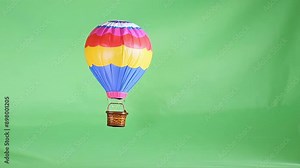 Miniature Hot Air Balloon- A tiny hot air balloon gently swaying in the center against a green screen. The colorful design adds a whimsical, adventurous feel