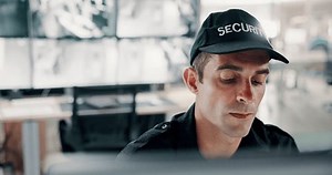 Man, security guard and control room with radio for surveillance or monitoring safety in building. Male person, CCTV operator or officer with speaker for signal response, footage or observation check