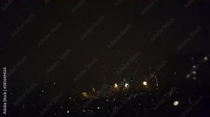 Rain flows down the window pane against the backdrop of the night city lights. The sky is lit by lightning to the sound of rain Stock Video