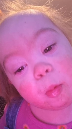 Zoë Grimes on Instagram: "Mummy sneaking in behind me with a face wipe to get rid of the evidence of me having a coco pop cereal bar before nursery this morning and me modelling my funky new pinafore dress Mummy got me in a sneaky Next order 🤣⭐️🩷⭐️ #positiveaboutdownsyndrome #downsyndromeuk #downsyndromeawareness #theluckyfew"