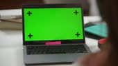 Close-up green screen laptop with video chat and unrecognizable...