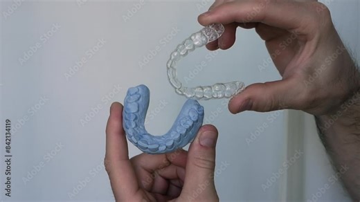 Demonstration of a dental aligner. Aligners for correcting the position of the teeth of the upper or lower jaw. Mouth guard and model for human teeth.