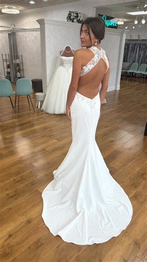 For the bride who wants to make a ✨GLAM STATEMENT✨ on their wedding day. This breathtaking fitted wedding gown is the definition of elegant drama. Featuring a sheer illusion high neckline with intricate beading, a sculpted crepe skirt, and a jaw-dropping open back finished with delicate buttons, this dress was made to turn heads from every angle. The high neckline is intricately beaded to add a luxurious flare to the entire look. Are you loving this wedding gown? Let us know in the comments. 🤍 