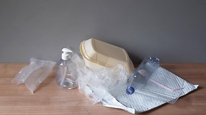 household plastic waste - stop motion animation - heap of domestic plastic trash such as bottles bags containers and packaging material