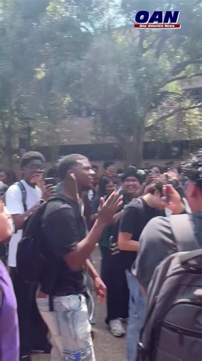 Texas State University has expelled a student who mocked Charlie Kirk’s killing and spit at his supporters. The incident happened Monday on the San Marcos campus at the Fighting Stallions statue. The event was a memorial organized by the campus chapter of Turning Point USA to honor Charlie Kirk after his death. During the memorial, the student was filmed mocking the assassination by pretending to be shot and spitting at supporters, sparking widespread backlash. Subscribe to OAN LIVE for more sto