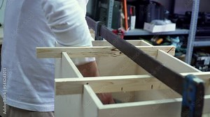 Close up on artisan hands measuring a wooden box with metal ruler in a workshop