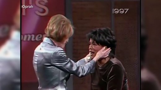 Oprah Winfrey cries as Mary Tyler Moore surprises her in 1997