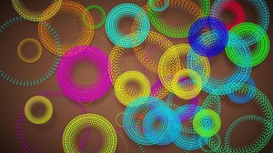 This looping 3D animation features cartoon-style rings with zigzag patterns rotating against a backdrop, resembling colorful ripples on water.