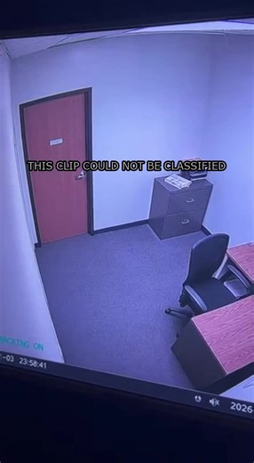 An overnight office feed shows a subtle doorframe shift that the system flags, yet nothing else moves. The footage cuts off mid‑scene, leaving the anomaly unresolved.