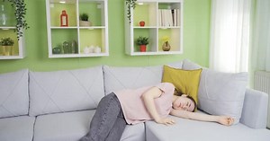 Young asian woman fainting at home.