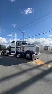 stretched out peterbilt rolling through intersection