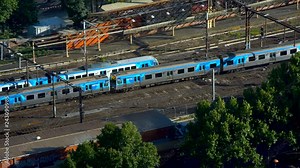 Comeng trains travelling along railway track Melbourne Australia