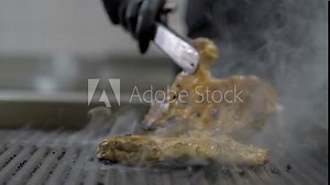 The flames in the kitchen of the restaurant. The chef prepares a steak flambe
