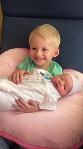 Adorable Sibling Moment: Big Brother Meets Baby Sister