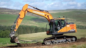Massive Doosan excavator shaping rural terrain
