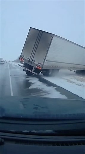 Dashcam Captures Semi Truck Sliding Off Icy Highway in North Dakota North Dakota- Dashcam footage recorded on a highway in North Dakota shows a semi truck losing control on ice-covered pavement and sliding off the roadway as winter conditions worsen. The video captures the truck fishtailing across lanes before drifting onto the shoulder and leaving the highway, narrowly avoiding other vehicles traveling nearby. Traffic behind the semi can be seen slowing and activating hazard lights as drivers r