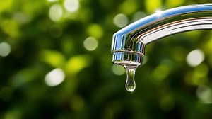 Download Water tap with dripping water droplet closeup macro for free