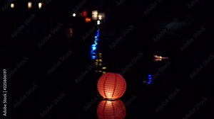 Festival of lanterns on the water. Water lantern in the shape of a Lotus with a candle flame floating at night on the water.