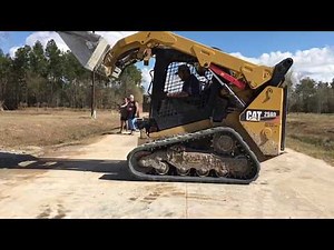 Cat 259D skid steer spreading gravel