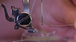 Threading a sewing machine needle - Free Stock Video