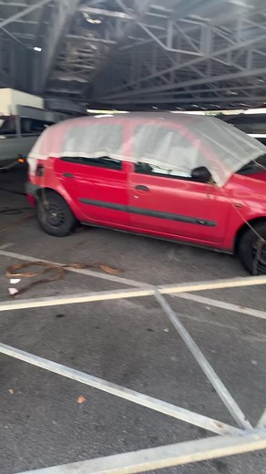 Red Car Under Overpass: Support Structure Insights