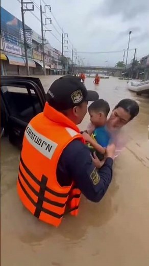 Helping children get out of a car during a flood#