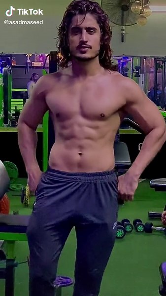 Muscular Male Flexing in Modern Gym Environment