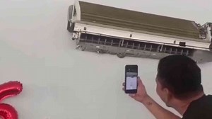 Cafe owner shocked to find python hiding in air conditioner