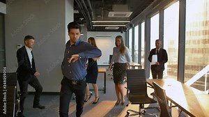 Businesspeople start dancing in office like in musical.
