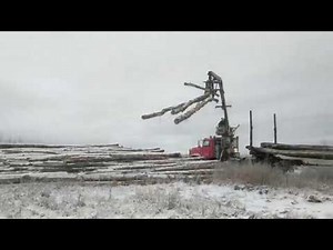 Unfolding the self loading log truck, and loading a few logs