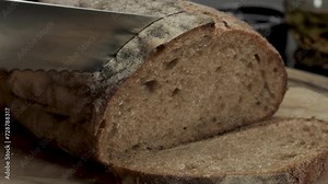 Cutting slice of homemade Crusty rye bread