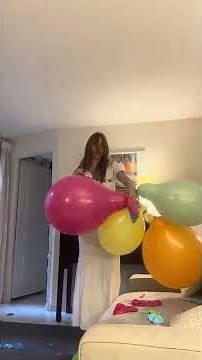 Girl pops a bunch of balloons