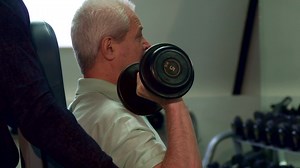 Download Trainer helps senior client during the training for free