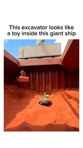 This Excavator Looks Like a Toy Inside a Giant Cargo Ship