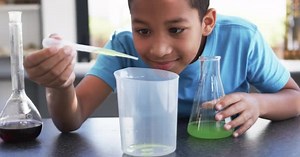 School Science Lab Classroom Young African American Student Conducts Experiment