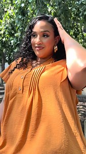 The Flounced Pleated Dress? A whole moment🧡. It moves with you, flatters every curve, and turns heads without trying. Shop now while your size is still in stock — this one won’t wait around. | Ashley Stewart