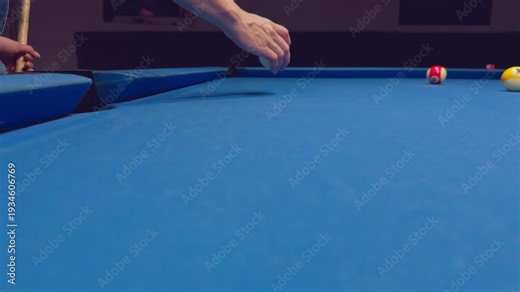 Woman Removing White Cue Ball From Pool Table Pocket While Preparing Next Shot In Calm Focused Game Moment