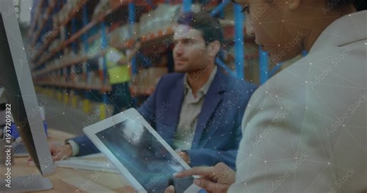 Lead tapping tablet updating stock, manager observing and typing, camera pulling into warehouse