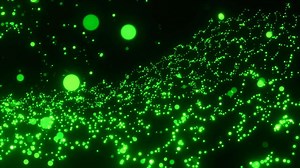 Flying round shaped particles on a black background. Motion. Beautiful spheres in outer space, glowing balls.