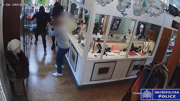 Moment balaclava-clad robbers attack antiques dealer with a hammer
