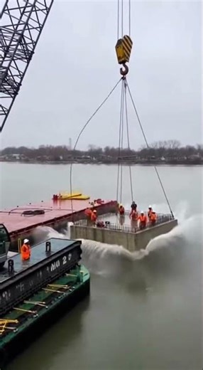 Shocking bridge failure concrete slabs break, excavator plunges, steel beams twist, workers scramble